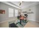 Cozy office area with a ceiling fan and a large desk with dual monitors at 1607 Laurel Brook Ln, Port Charlotte, FL 33953