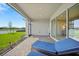 Covered patio featuring outdoor seating, lake views, and access to the home's interior via sliding glass doors at 1607 Laurel Brook Ln, Port Charlotte, FL 33953
