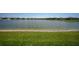 Scenic view of a pond with a fountain, framed by a lush green lawn at 1607 Laurel Brook Ln, Port Charlotte, FL 33953