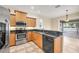 Well-equipped kitchen featuring stainless steel appliances, granite counters, and access to the dining area at 1795 Walden Ct, Englewood, FL 34224