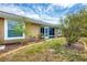 A charming backyard features lush green grass, landscaping, and a view of the home's exterior at 182 Rotonda W Blvd # B, Rotonda West, FL 33947