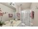 Well-lit bathroom featuring a glass enclosed shower and vanity at 182 Rotonda W Blvd # B, Rotonda West, FL 33947