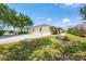 Exterior view of the home highlighting the three-car garage, long driveway and front entrance at 182 Rotonda W Blvd # B, Rotonda West, FL 33947