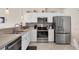 Well-equipped kitchen with stainless steel appliances, white cabinets and tiled backsplash at 182 Rotonda W Blvd # B, Rotonda West, FL 33947