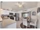 Modern kitchen with stainless steel appliances, white cabinetry, and a cozy breakfast nook at 182 Rotonda W Blvd # B, Rotonda West, FL 33947