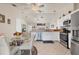 Bright kitchen with white cabinets, stainless steel appliances, and eat-in dining area at 182 Rotonda W Blvd # B, Rotonda West, FL 33947