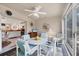 A sun-filled room that features a ceiling fan, sliding glass windows, table with chairs, and a view of the kitchen at 182 Rotonda W Blvd # B, Rotonda West, FL 33947