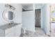 Bathroom with an updated vanity, modern fixtures, and a glass-enclosed shower at 1926 Georgia Ave, Englewood, FL 34224