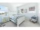 Bright bedroom with a white bed, coastal decor, and lots of natural light at 1926 Georgia Ave, Englewood, FL 34224