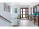Inviting foyer showcasing a wooden front door, staircase, light walls, and elegant decor at 1926 Georgia Ave, Englewood, FL 34224