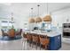 Bright, modern kitchen features white cabinets, stainless steel appliances, and a large island with pendant lighting at 1926 Georgia Ave, Englewood, FL 34224