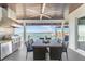 Outdoor kitchen and dining area with lake view and ceiling fan at 1926 Georgia Ave, Englewood, FL 34224