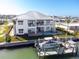 Waterfront house featuring a private dock, boat lift, backyard swimming pool, and balconies with water views at 1926 Georgia Ave, Englewood, FL 34224