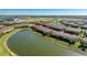 Waterfront townhome community surrounded by a scenic lake, providing tranquil and picturesque views at 20231 Lagente Cir, Venice, FL 34293