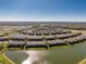 Waterfront community featuring many townhomes and a scenic lake, creating a serene and picturesque setting at 20231 Lagente Cir, Venice, FL 34293