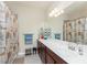 Bathroom featuring a long vanity, plenty of storage, and nautical decor that provides a cozy feel at 20231 Lagente Cir, Venice, FL 34293