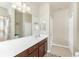 Large bathroom featuring a long vanity, a large mirror, and a tub shower for a luxurious feel at 20231 Lagente Cir, Venice, FL 34293