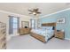 Main bedroom featuring a ceiling fan and neutral toned furniture with blue accents at 20231 Lagente Cir, Venice, FL 34293