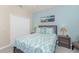 Bedroom featuring aqua walls, a queen-sized bed, and coastal-themed decor for a tranquil setting at 20231 Lagente Cir, Venice, FL 34293