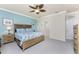 Comfortable bedroom featuring a ceiling fan, neutral walls, and a king-sized bed with floral bedding at 20231 Lagente Cir, Venice, FL 34293