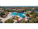 Aerial view of resort pool with palm trees and many lounge chairs and tables at 20231 Lagente Cir, Venice, FL 34293