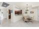 Open concept dining area with tile flooring, chandelier, and views to the kitchen at 20231 Lagente Cir, Venice, FL 34293
