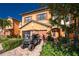 Two-story home showcasing a brick paver driveway, mature landscaping, and a convenient golf cart at 20231 Lagente Cir, Venice, FL 34293