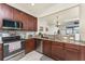 Kitchen featuring stainless steel appliances, granite countertops and dark wood cabinets at 20231 Lagente Cir, Venice, FL 34293