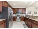Kitchen featuring stainless steel appliances, rich wood cabinets, and granite countertops at 20231 Lagente Cir, Venice, FL 34293