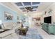 Open concept living space with coffered ceilings and view to the kitchen and dining areas at 20231 Lagente Cir, Venice, FL 34293