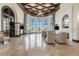 Elegant lounge features high ceilings, travertine floors, stylish furniture, and fireplace at 20231 Lagente Cir, Venice, FL 34293