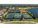 Aerial view of community tennis courts with walking path and manicured grounds at 20231 Lagente Cir, Venice, FL 34293