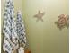 Bathroom wall with striped towels, starfish and turtle decorations at 20279 Lagente Cir, Venice, FL 34293