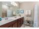 Bathroom with a long vanity with a white top, dark wood cabinets and seaside decor at 20279 Lagente Cir, Venice, FL 34293