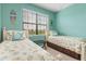 Bedroom featuring two twin beds, sea-themed decor, and a bright, inviting atmosphere at 20279 Lagente Cir, Venice, FL 34293