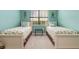 Bedroom featuring two twin beds, sea-themed decor, and a bright, inviting atmosphere at 20279 Lagente Cir, Venice, FL 34293
