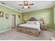 Cozy bedroom boasts a king-size bed, ceiling fan, and coastal decor touches, creating a tranquil retreat at 20279 Lagente Cir, Venice, FL 34293