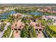 Aerial view of a gated community entrance featuring lush landscaping, palm trees and beautiful architecture at 20279 Lagente Cir, Venice, FL 34293