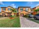 Attractive townhome showcasing attached garages, brick driveways, and well-maintained landscaping at 20279 Lagente Cir, Venice, FL 34293