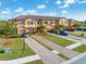 A beautiful two-story townhome with a private garage, and lush landscaping along a brick paved driveway at 20279 Lagente Cir, Venice, FL 34293