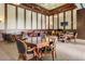 Spacious game room with multiple tables, chairs, and a television for entertainment at 20279 Lagente Cir, Venice, FL 34293