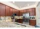 Well-equipped kitchen with stainless steel appliances, granite countertops, and ample cabinet space, creating a functional cooking area at 20279 Lagente Cir, Venice, FL 34293