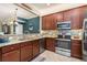 Well-equipped kitchen featuring granite countertops, stainless steel appliances, and rich wood cabinetry at 20279 Lagente Cir, Venice, FL 34293