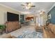 Spacious living room with tile floors, leather sofa, a flat-screen TV, and a breakfast nook at 20279 Lagente Cir, Venice, FL 34293
