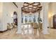 An elegant lounge with coffered ceilings, arched windows, columns and comfortable seating at 20279 Lagente Cir, Venice, FL 34293