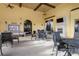 Outdoor patio with seating, a fireplace, and bulletin board for community events at 20279 Lagente Cir, Venice, FL 34293