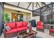 Relaxing screened patio with comfortable seating, ceiling fan and stylish decor for outdoor living at 20279 Lagente Cir, Venice, FL 34293