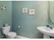 Powder room features toilet, sink, and beach-themed decor at 20279 Lagente Cir, Venice, FL 34293