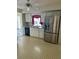 Kitchen features white cabinets, stainless steel appliances, view to lanai and tiled backsplash at 2259 Lee Ter, Port Charlotte, FL 33952