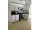 Kitchen showcasing modern stainless steel appliances, light countertops and white cabinets at 2259 Lee Ter, Port Charlotte, FL 33952